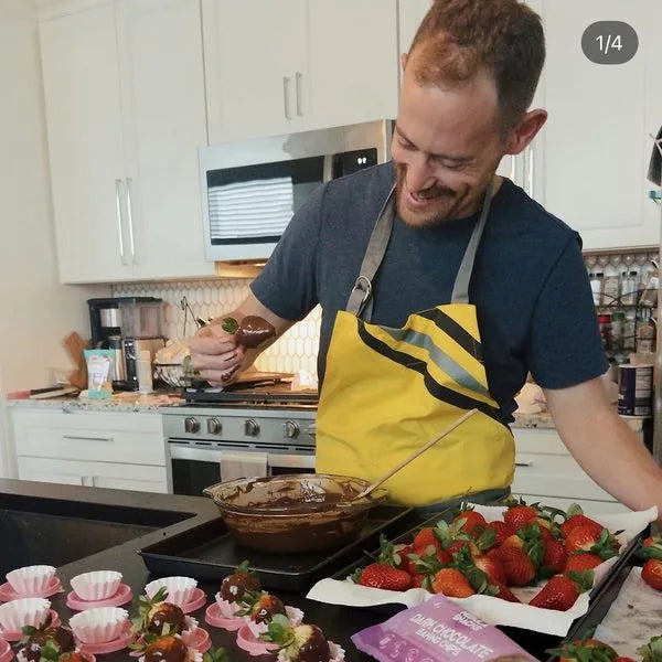 David dipping strawberries in melted Nebula dark chocolate baking chips
