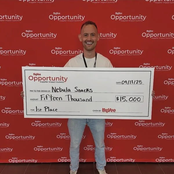 David holding a first-place check from Hy-Vee